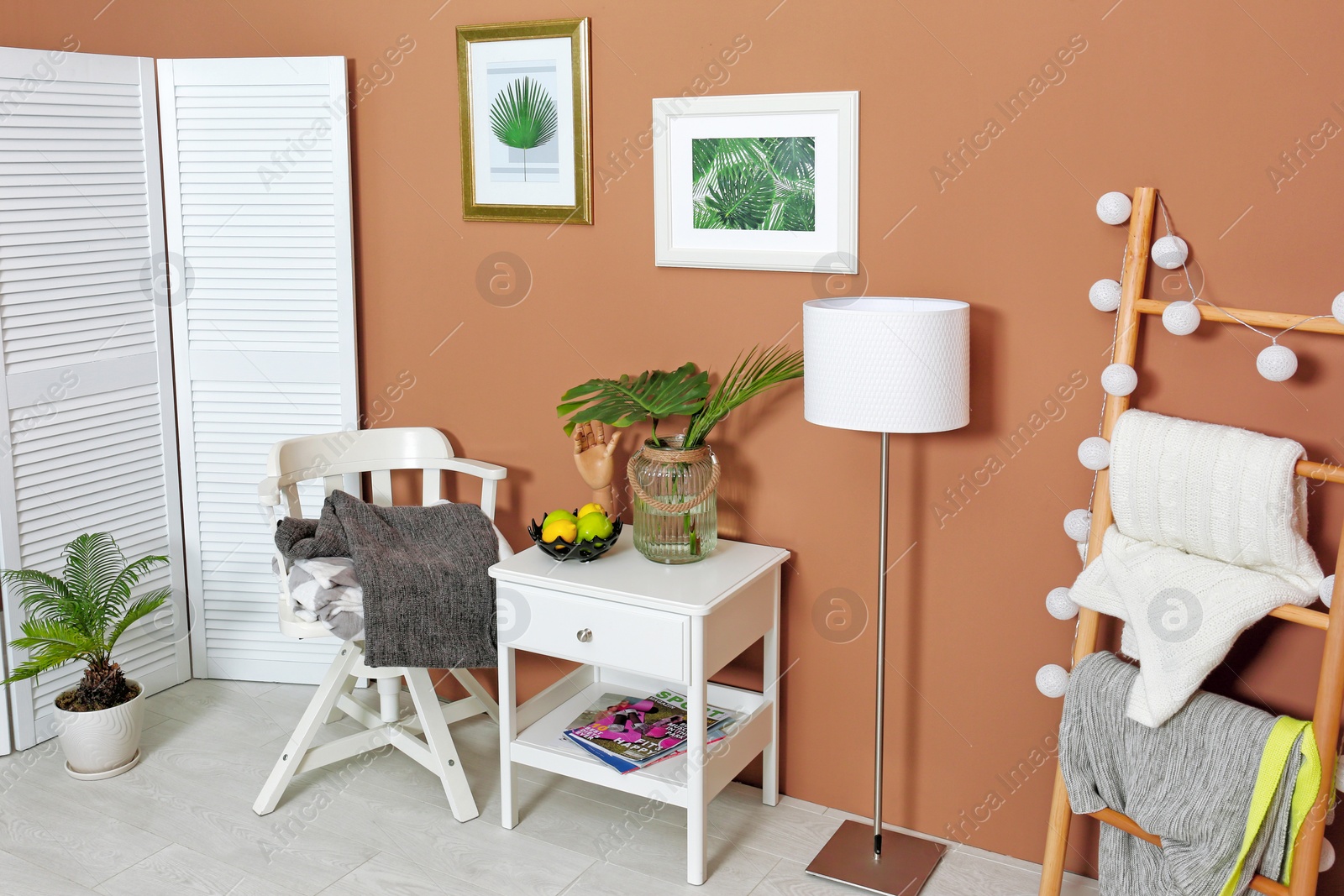 Photo of Stylish room interior with tropical leaves