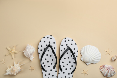 Flat lay composition with flip flops on beige background. Space for text