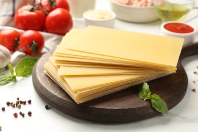 Photo of Ingredients for lasagna on white table, closeup