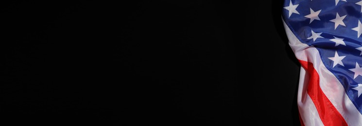 USA flag on black background, top view. Space for text