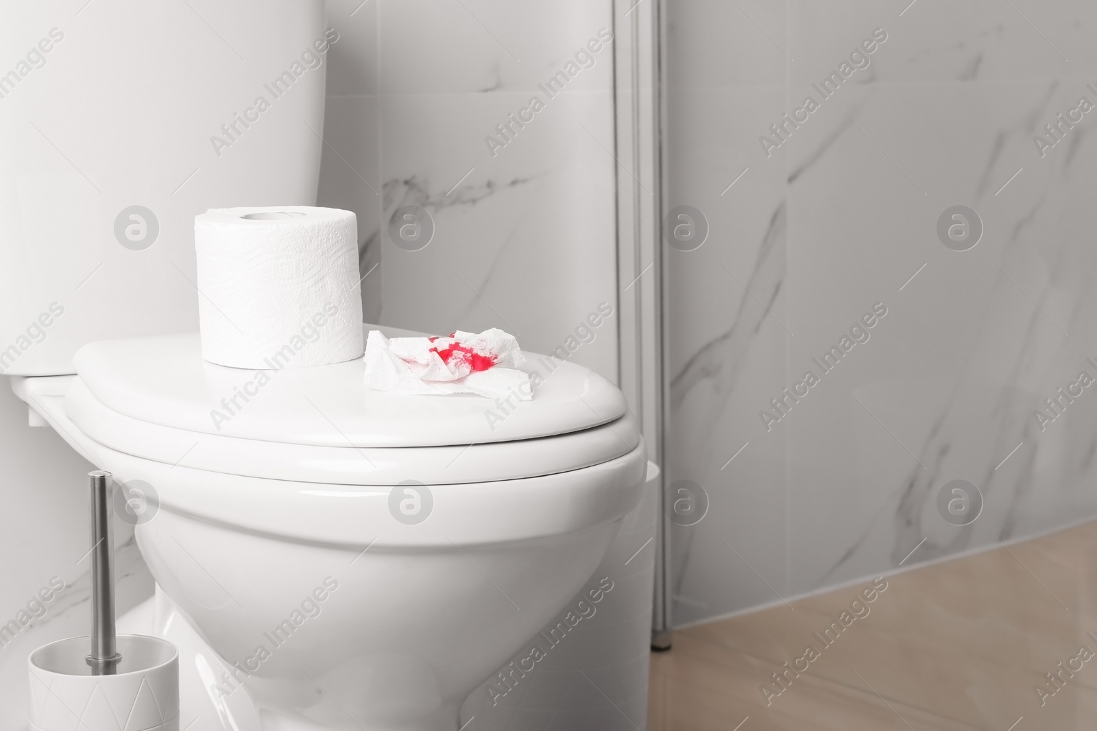 Photo of Sheet of paper with blood on toilet bowl in bathroom