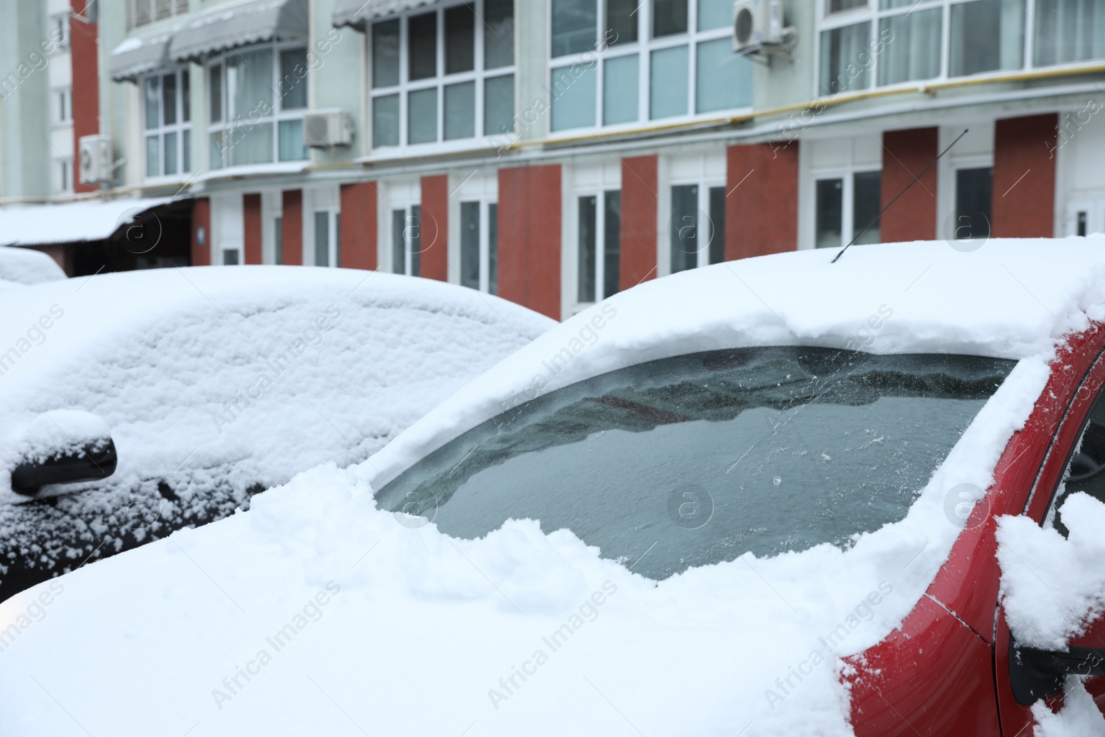 Photo of Car windshield cleaned from snow outdoors on winter day. Frosty weather