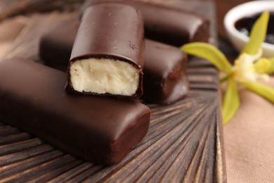 Photo of Glazed vanilla curd cheese bars served on table, closeup