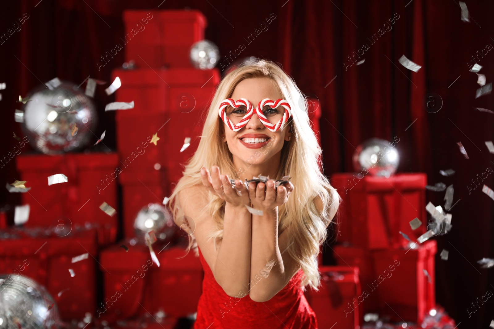 Photo of Beautiful woman with confetti at Christmas party