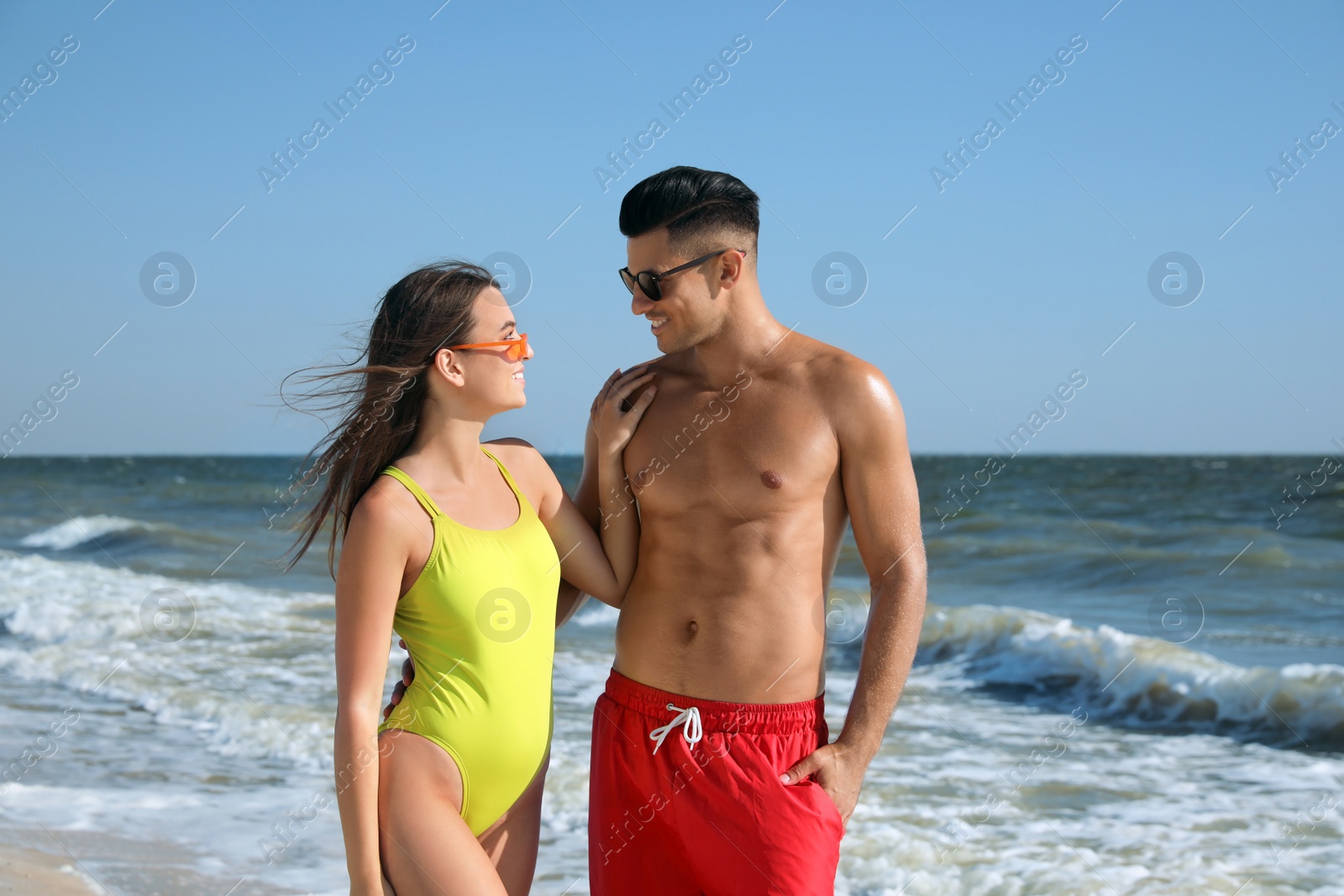 Photo of Lovely couple spending time together on beach