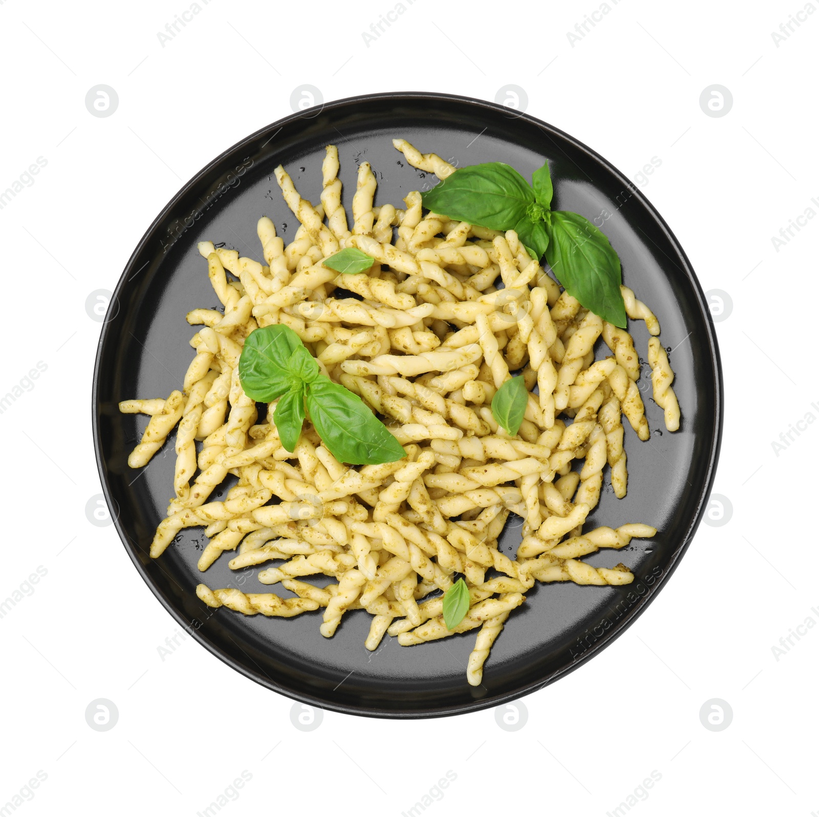 Photo of Plate of delicious trofie pasta with pesto sauce and basil leaves isolated on white, top view