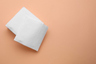 Photo of Stack of clean paper tissues on beige background, top view. Space for text