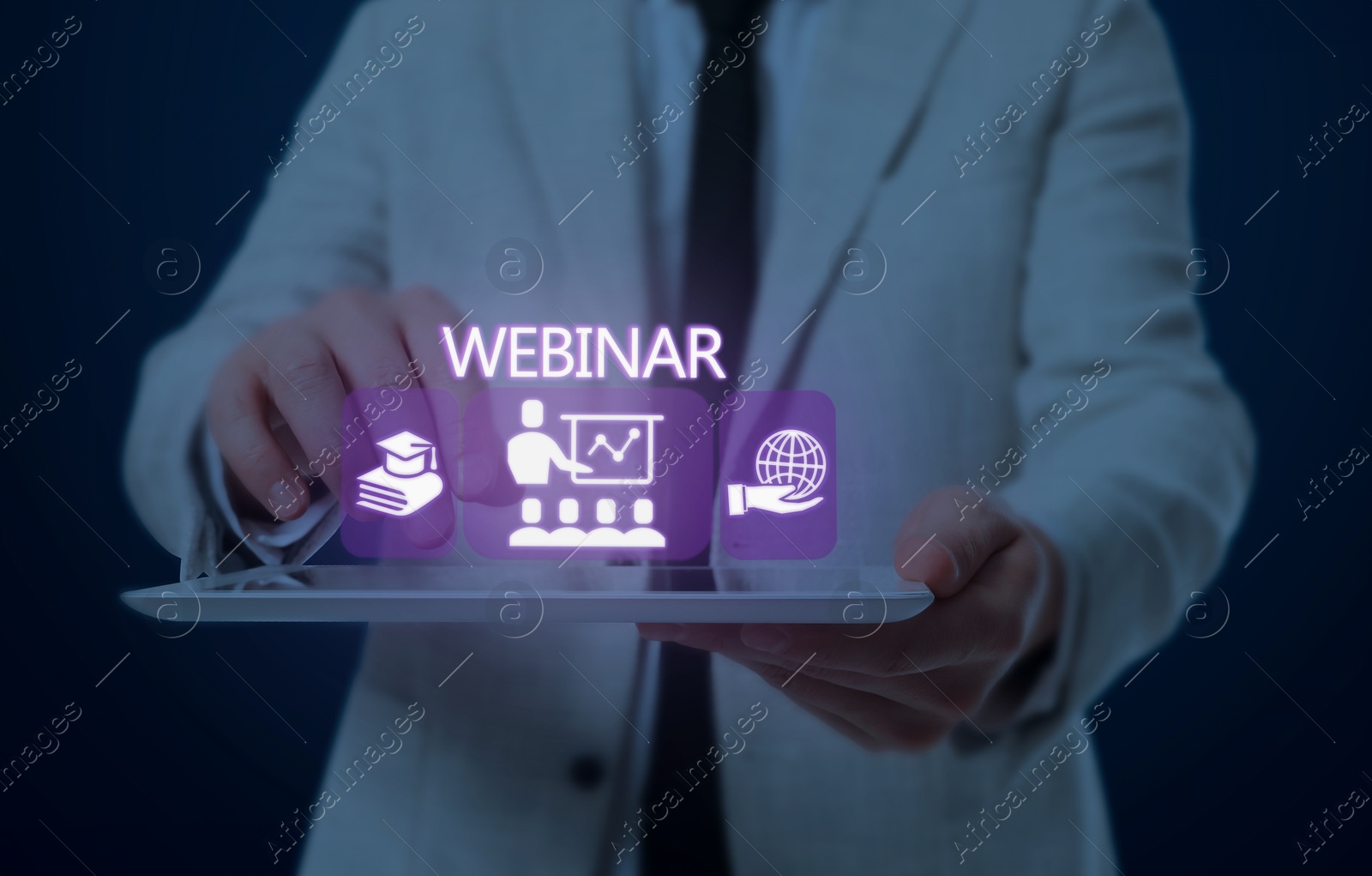 Image of Webinar. Man holding tablet on dark blue background, closeup. Virtual screen with icons over computer