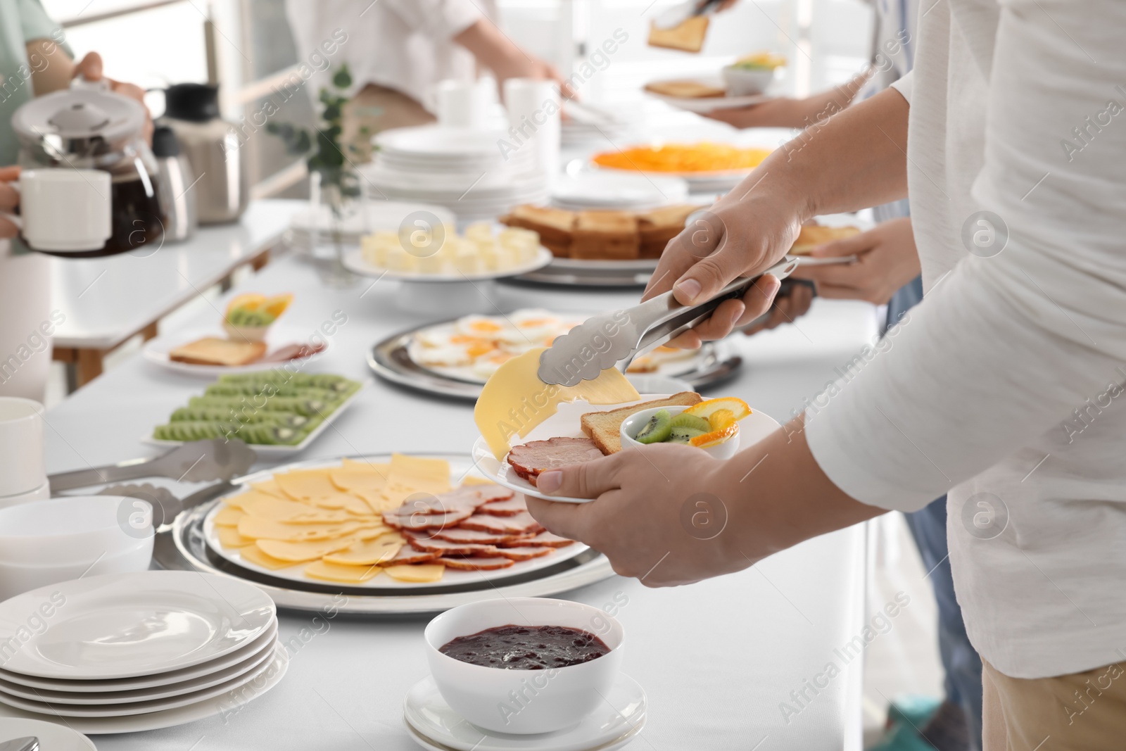 Photo of People taking food during breakfast, closeup. Buffet service