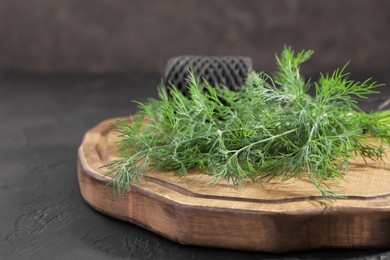 Photo of Fresh dill on grey table, closeup. Space for text