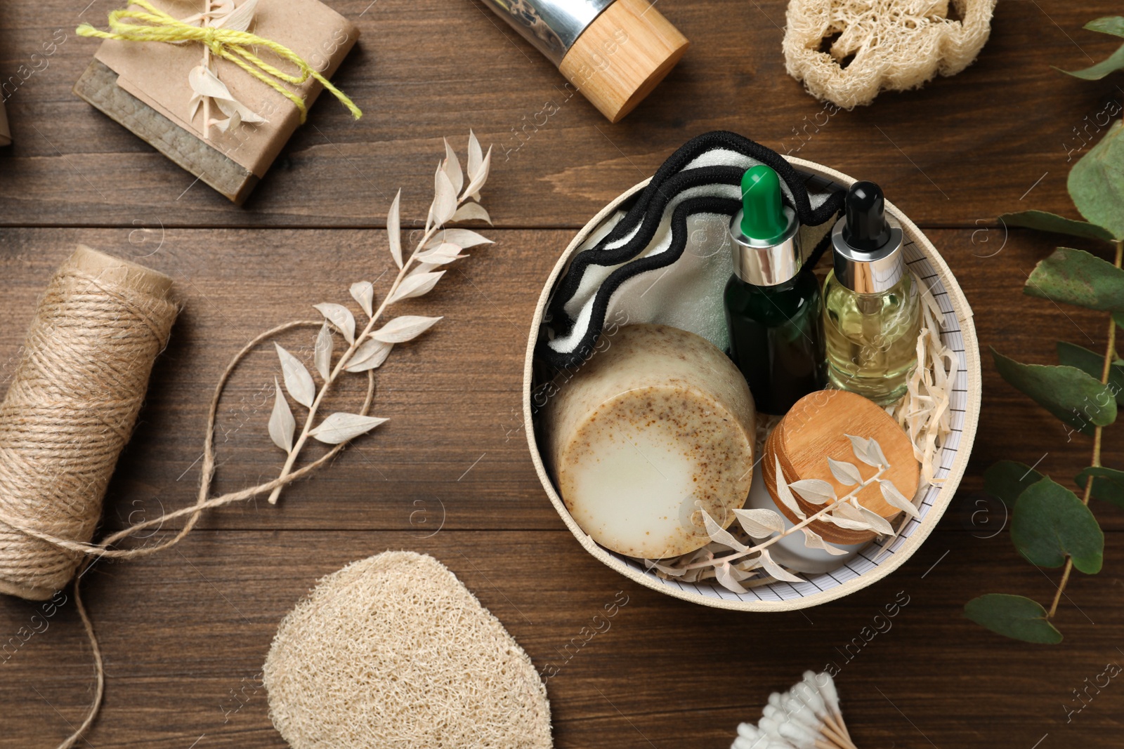 Photo of Box with eco friendly bathroom products on wooden table, flat lay