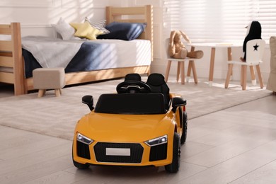Photo of Empty yellow toy car for child in light room