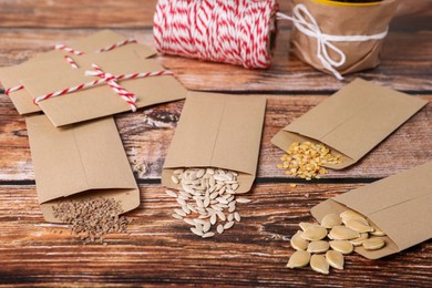 Photo of Many different vegetable seeds on wooden table