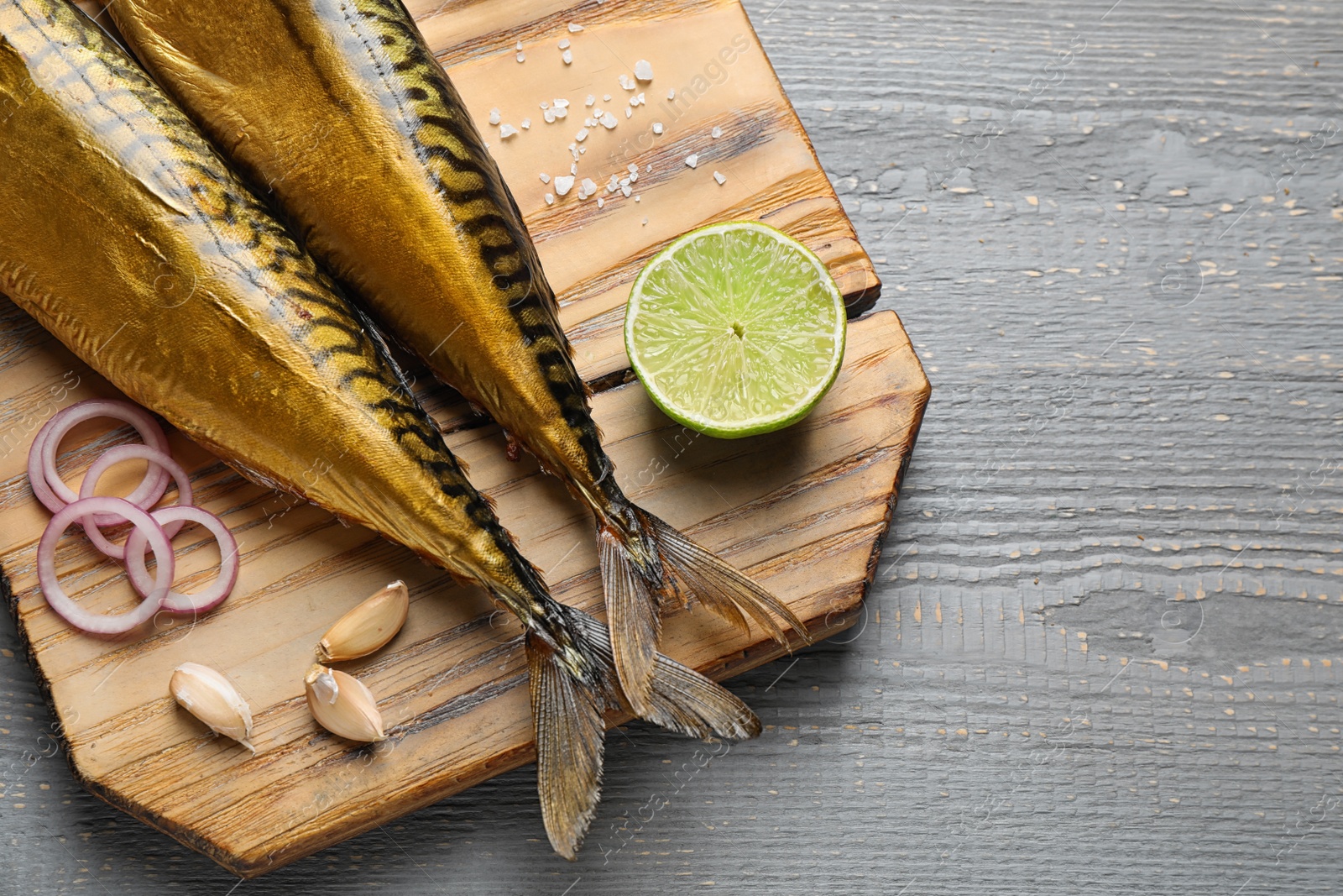 Photo of Tasty smoked fish on wooden table, top view