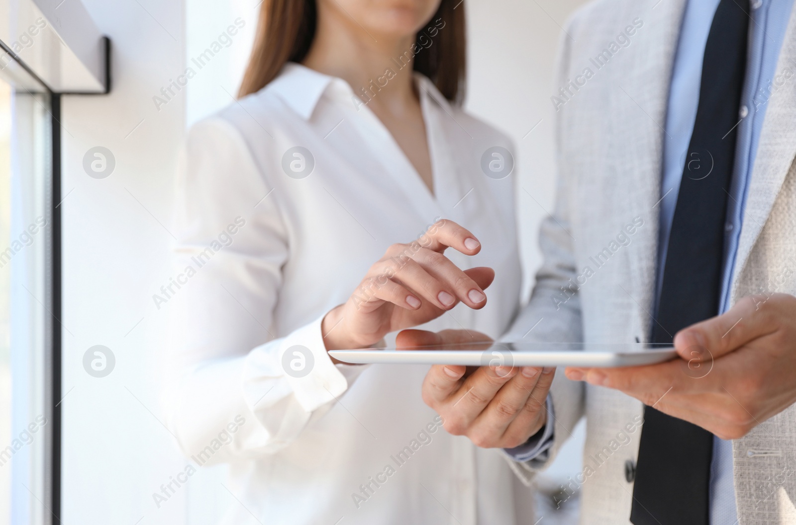 Photo of Business people working with modern tablet in office, closeup