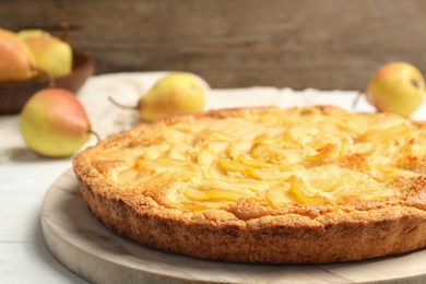 Photo of Delicious sweet pear tart on white table