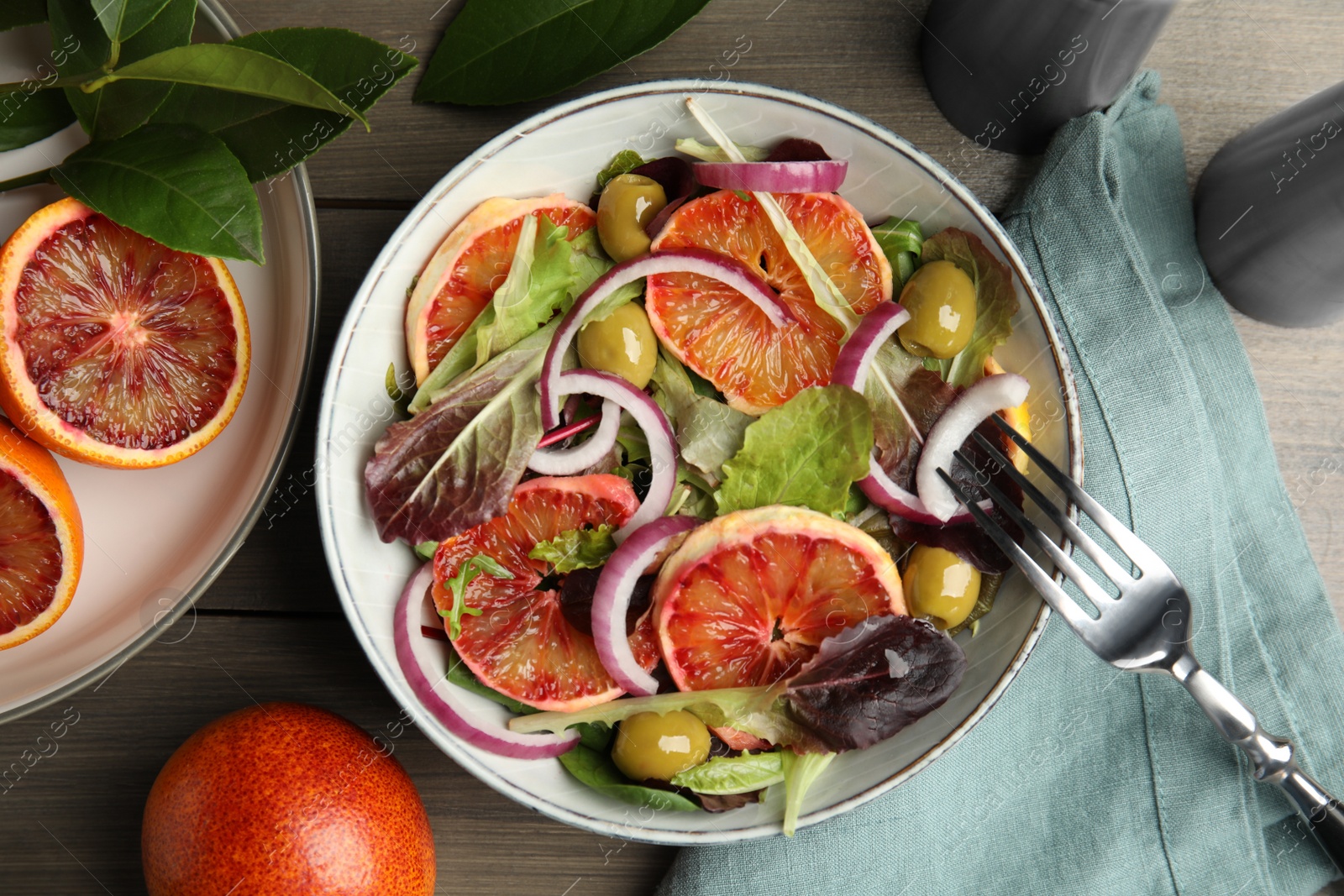 Photo of Delicious sicilian orange salad served on wooden table, flat lay