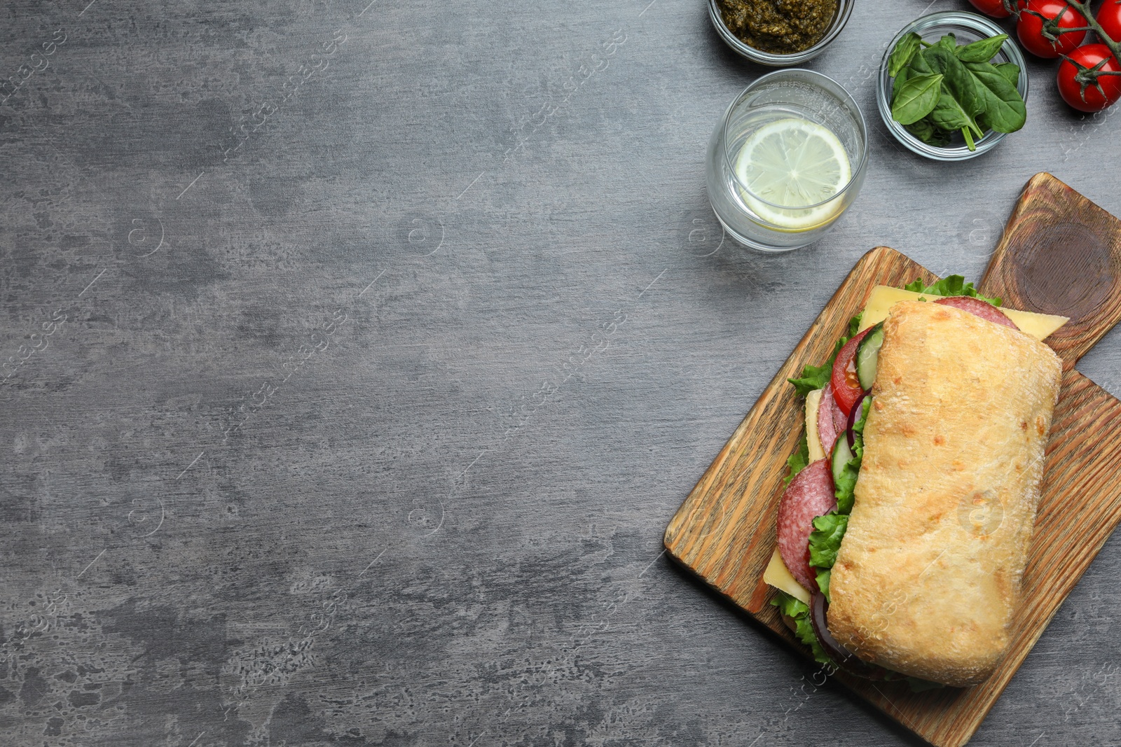 Photo of Flat lay composition with delicious sandwich on grey table. Space for text