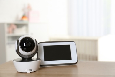 Baby monitor with camera on table in room. Video nanny