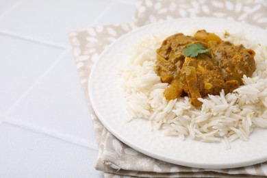 Photo of Delicious chicken curry with rice on white tiled table, closeup