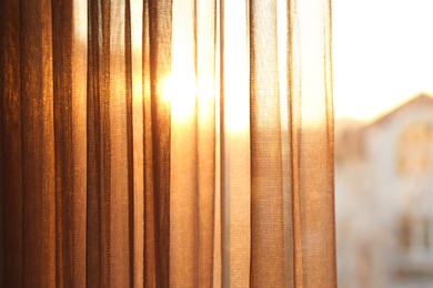 Photo of Window with beautiful transparent curtain, closeup view