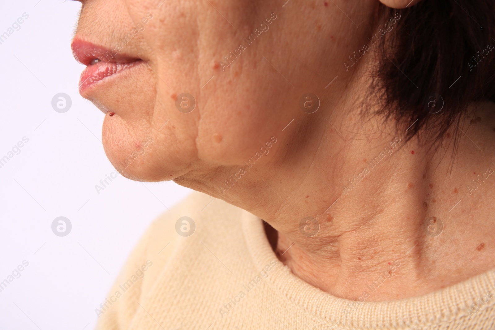 Photo of Closeup view of older woman on white background