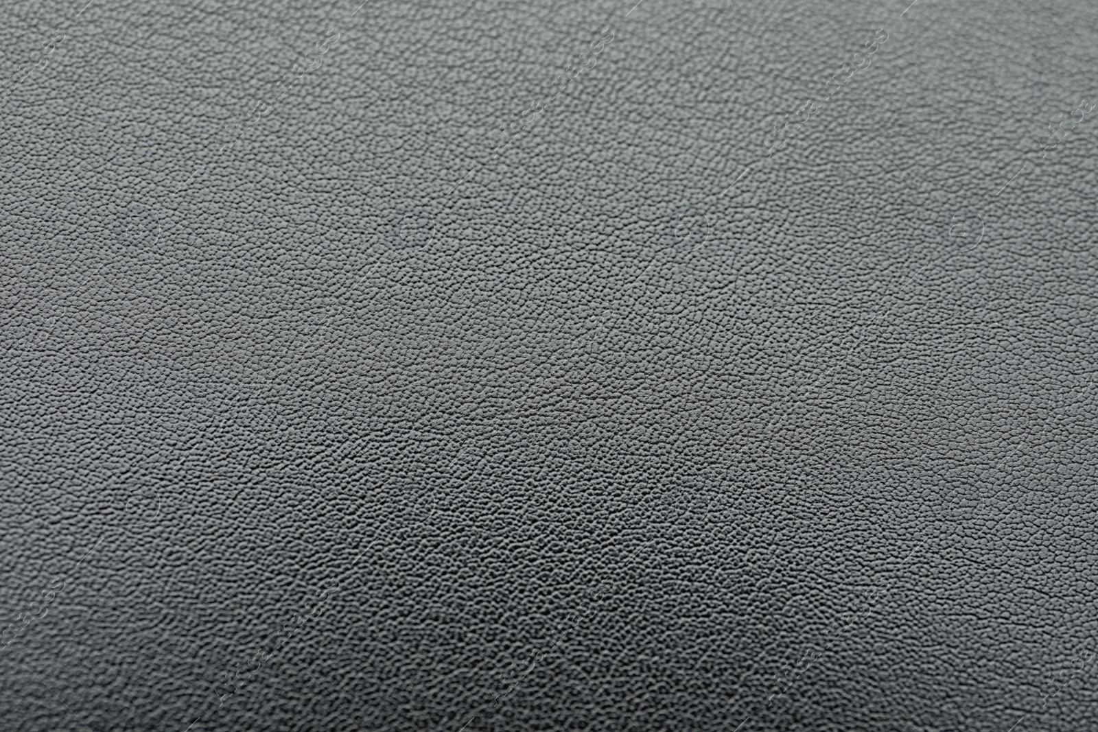 Photo of Texture of dark grey leather as background, closeup