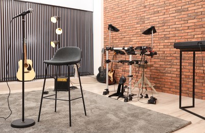 Photo of Modern music studio interior with different electronic instruments