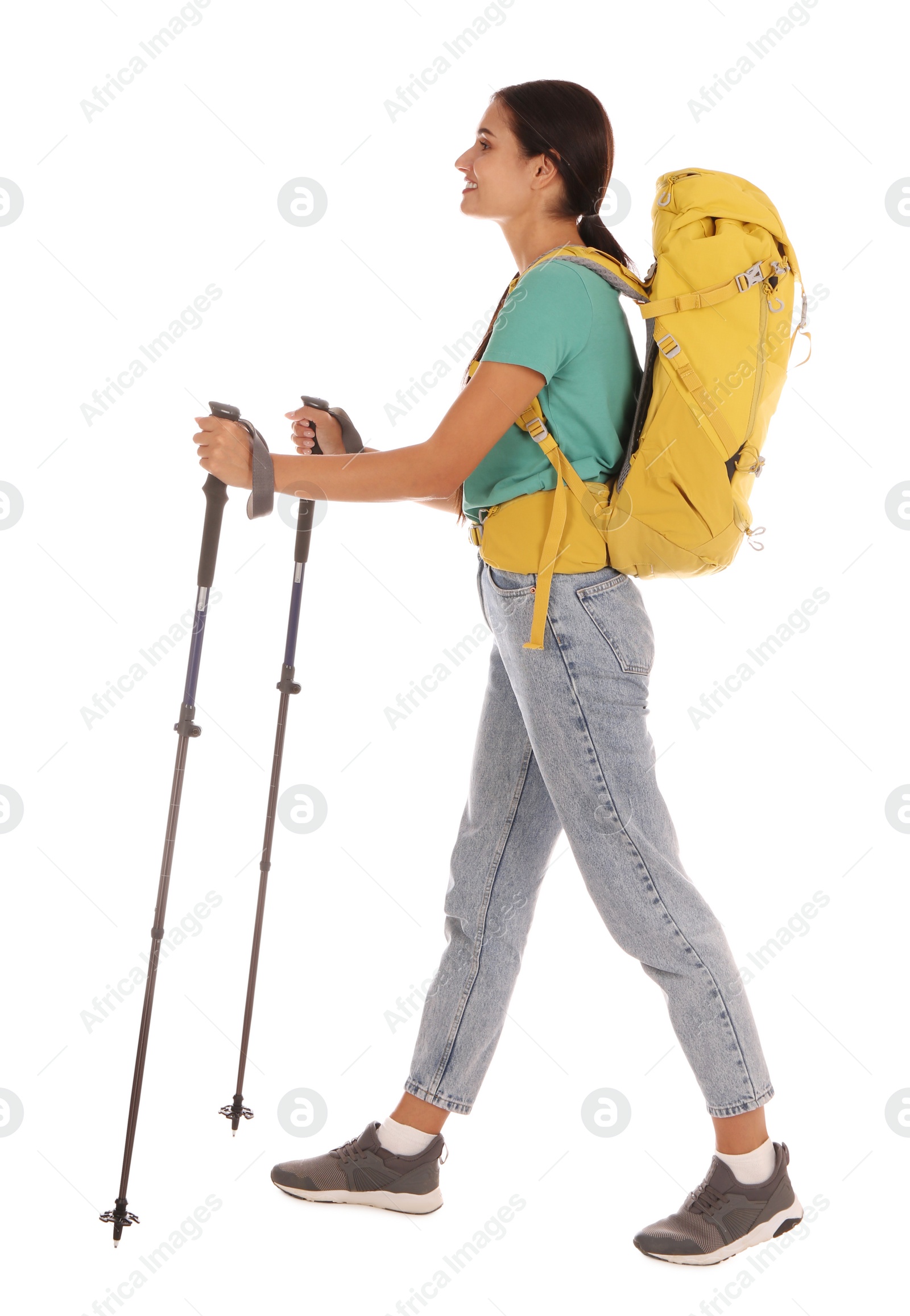 Photo of Female hiker with backpack and trekking poles on white background