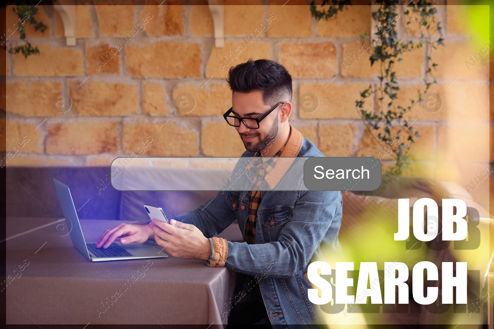 Image of Young man with laptop and smartphone at table in cafe. Job search