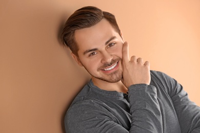 Photo of Portrait of young man with beautiful hair on color background