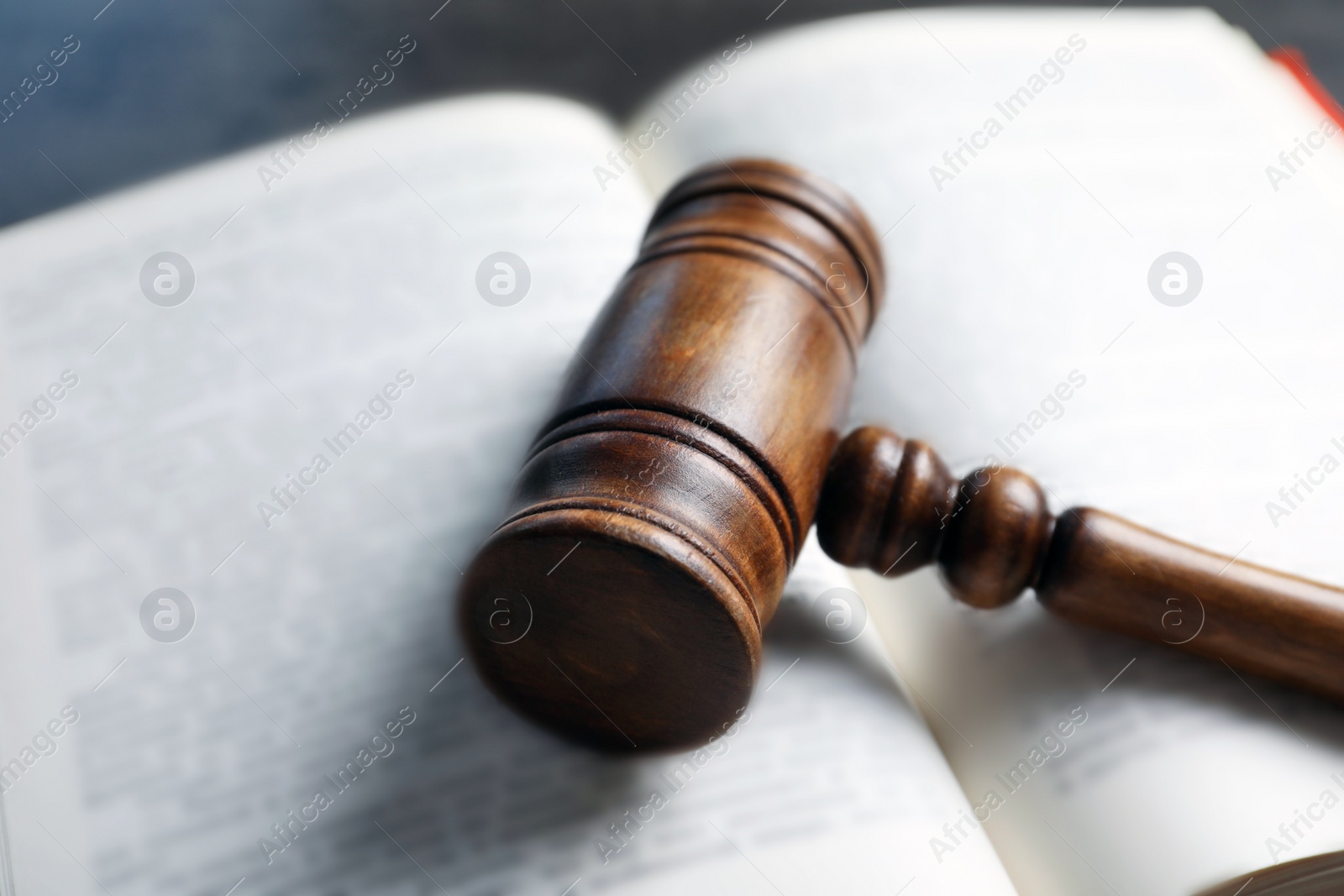 Photo of Wooden gavel and book, closeup. Law concept
