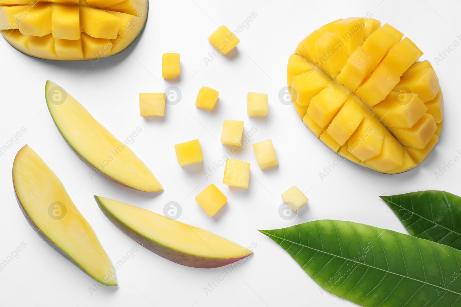 Photo of Cut fresh ripe mango fruits on white background, top view