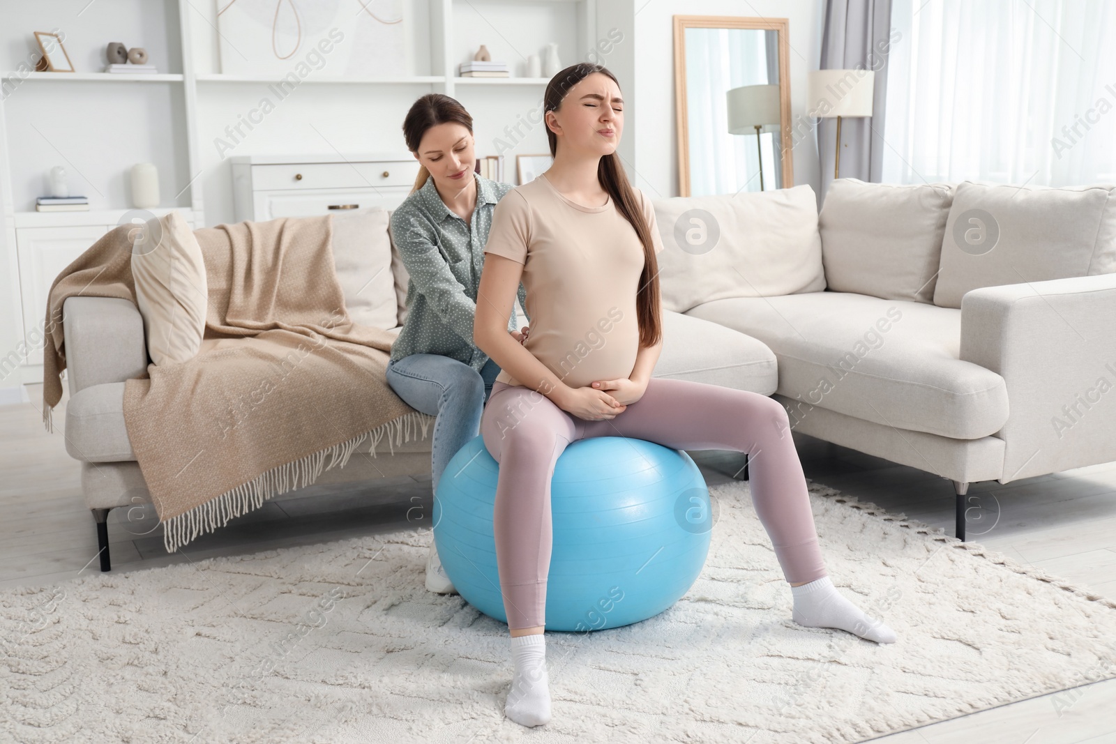 Photo of Doula working with pregnant woman at home. Preparation for child birth