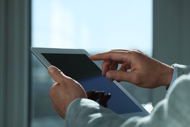 Closeup view of man using new tablet indoors