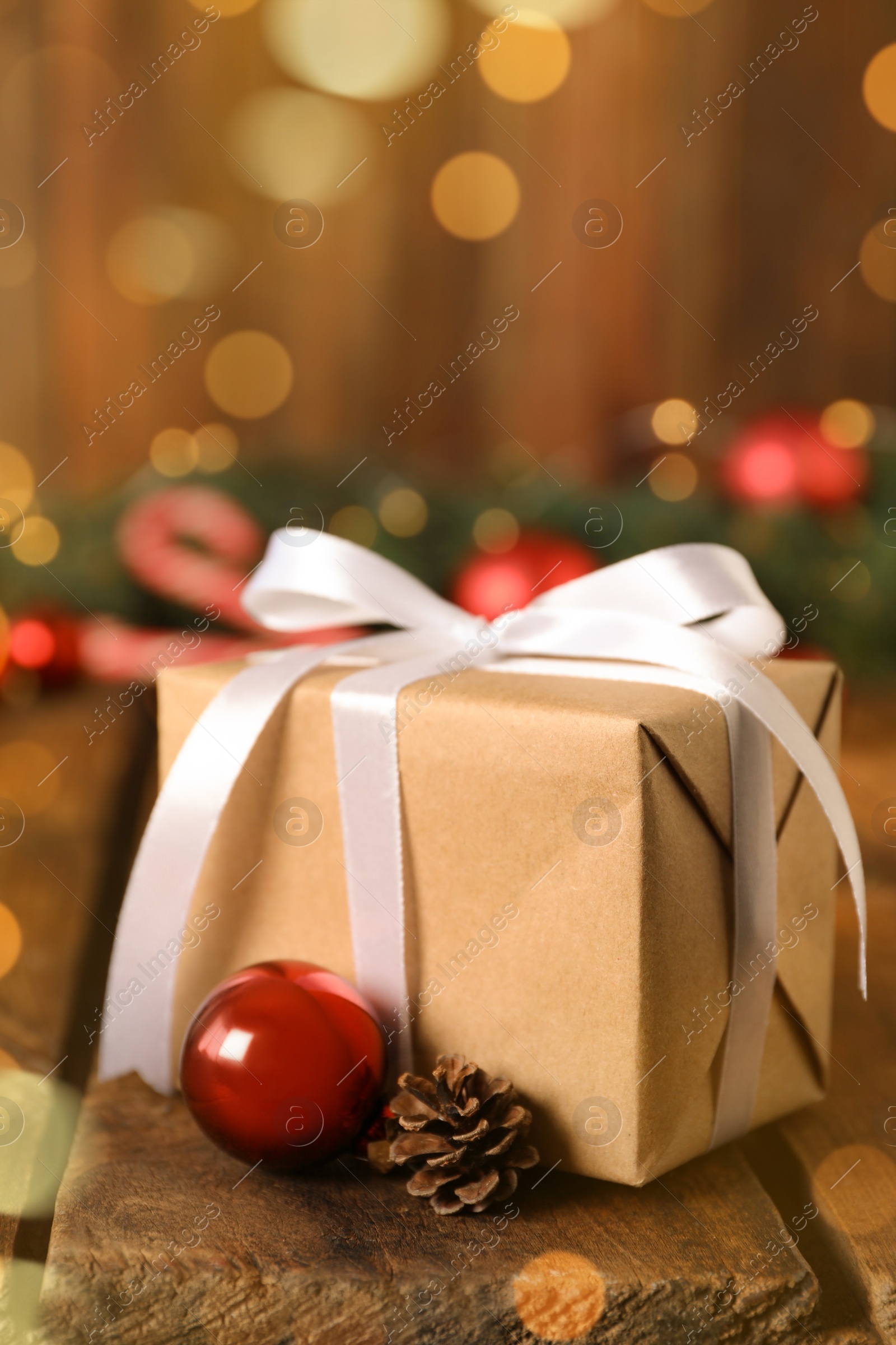 Photo of Christmas gift box and decor on wooden table, closeup