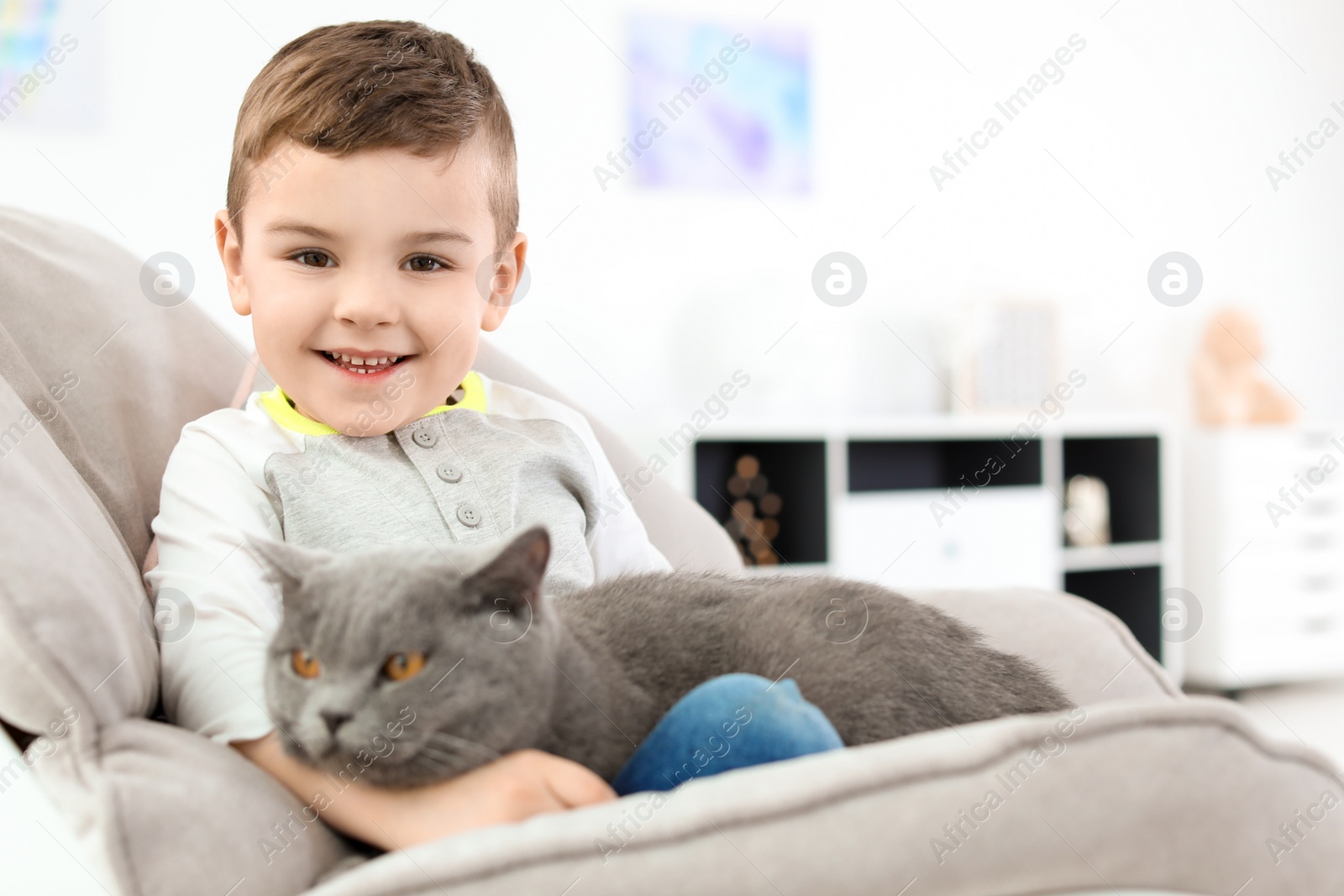 Photo of Cute little child with cat at home