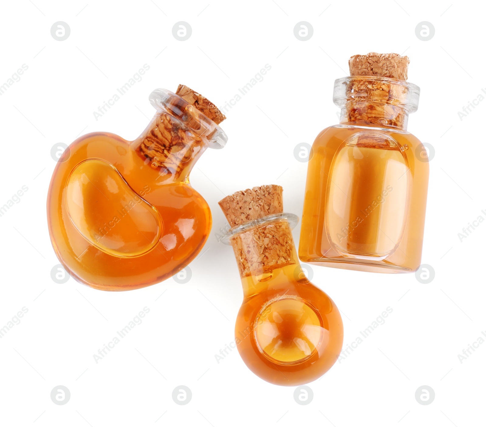 Photo of Bottles of love potion isolated on white, top view