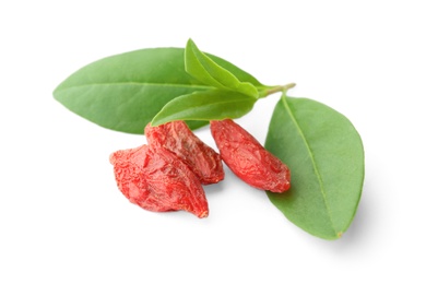 Tasty dried goji berries with leaves on white background