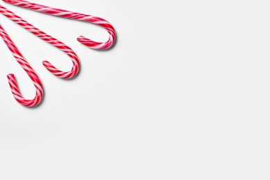 Sweet Christmas candy canes on white background, top view