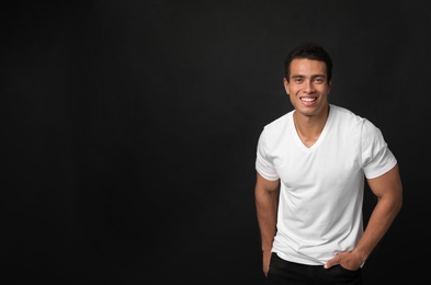 Photo of Handsome young African-American man on black background