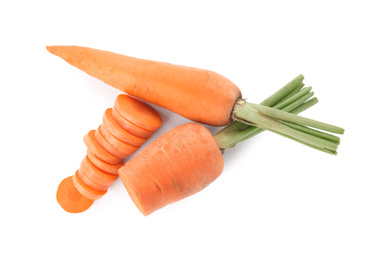 Whole and cut ripe carrots isolated on white, top view