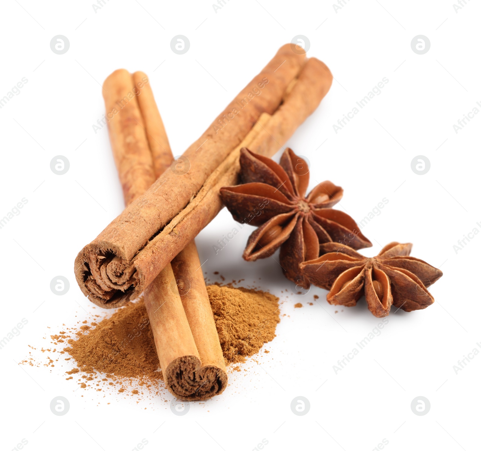 Photo of Dry aromatic cinnamon sticks, powder and anise stars isolated on white