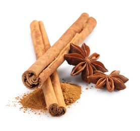 Dry aromatic cinnamon sticks, powder and anise stars isolated on white