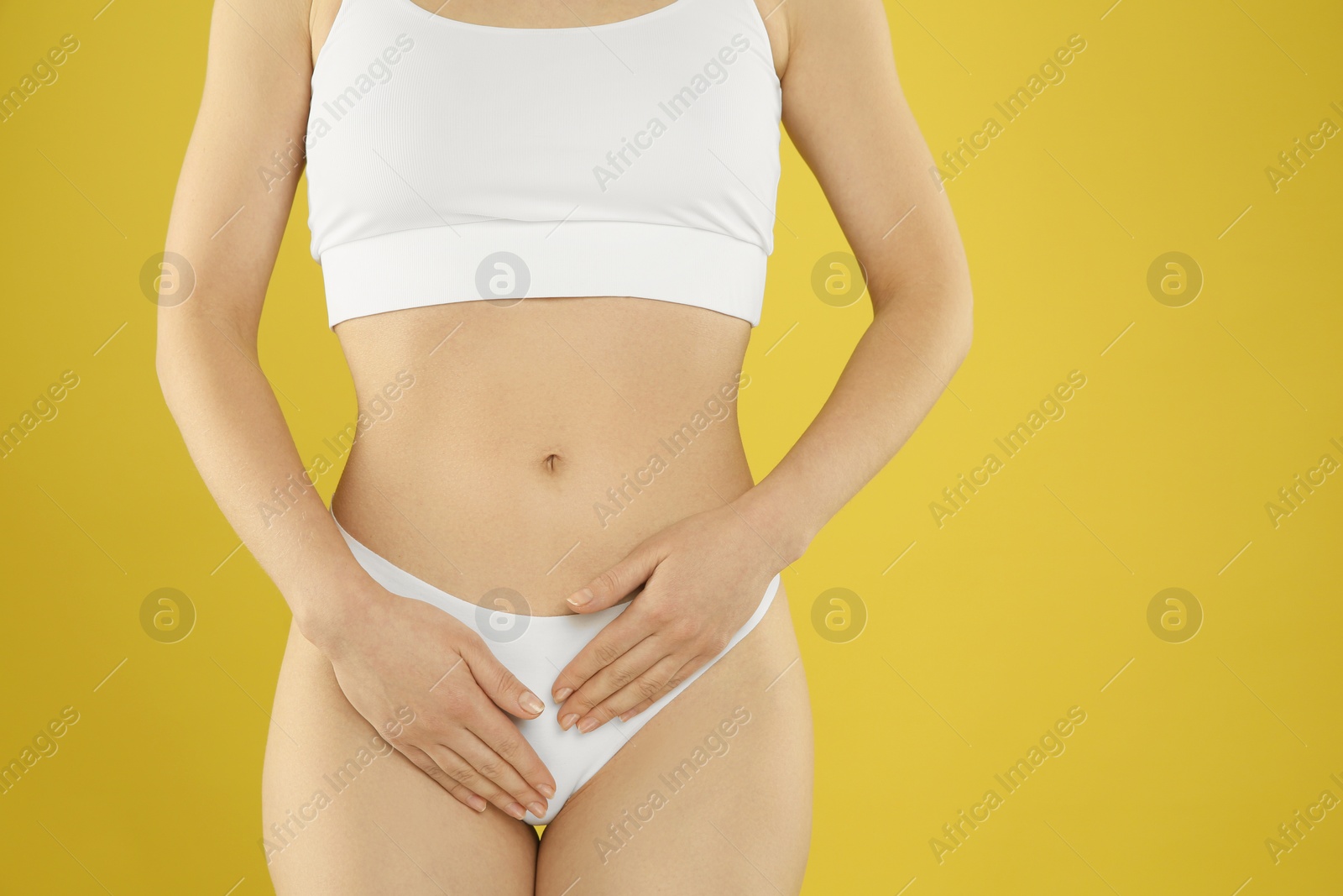 Photo of Gynecology. Woman in underwear on yellow background, closeup. Space for text