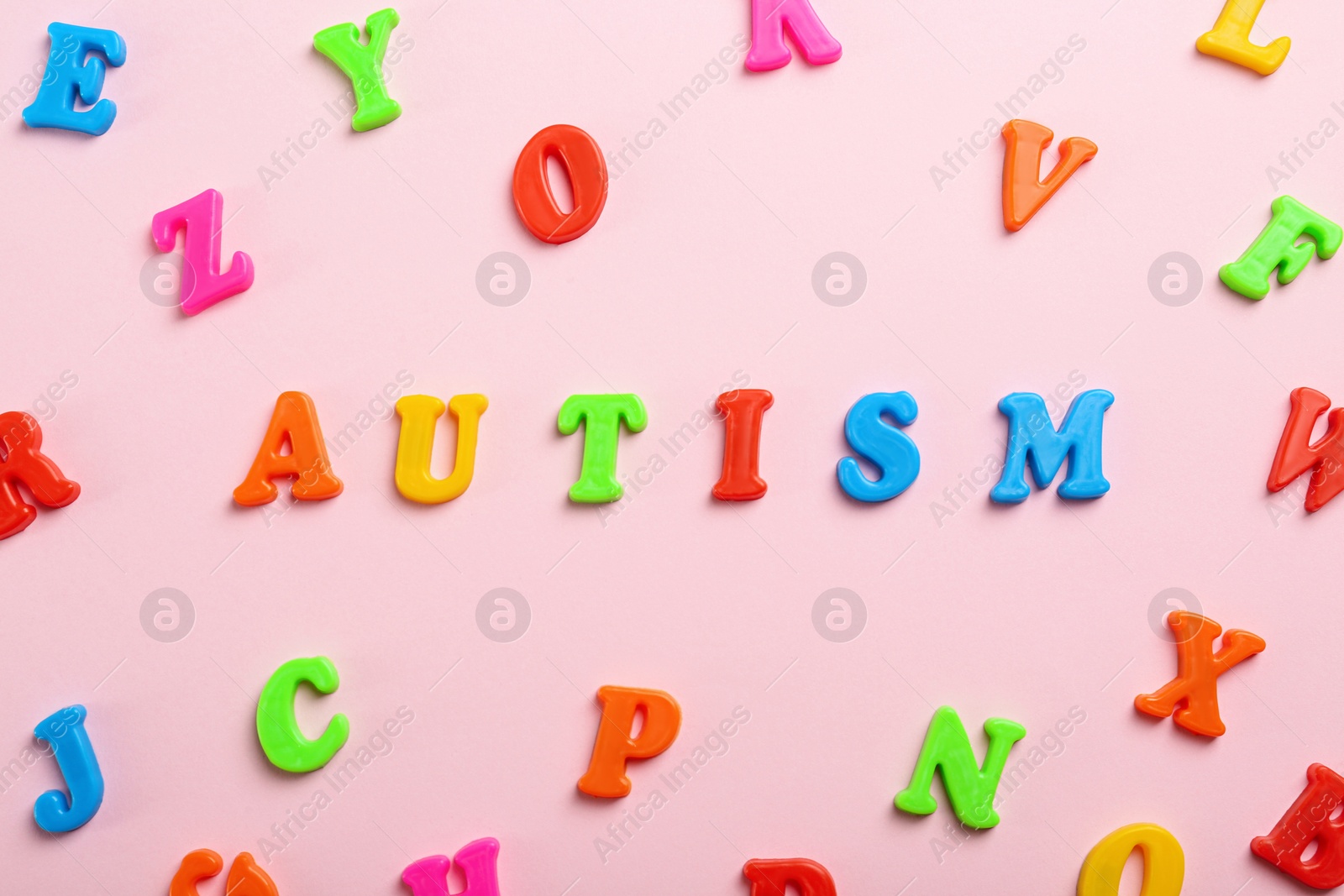 Photo of Flat lay composition with word Autism on pink background