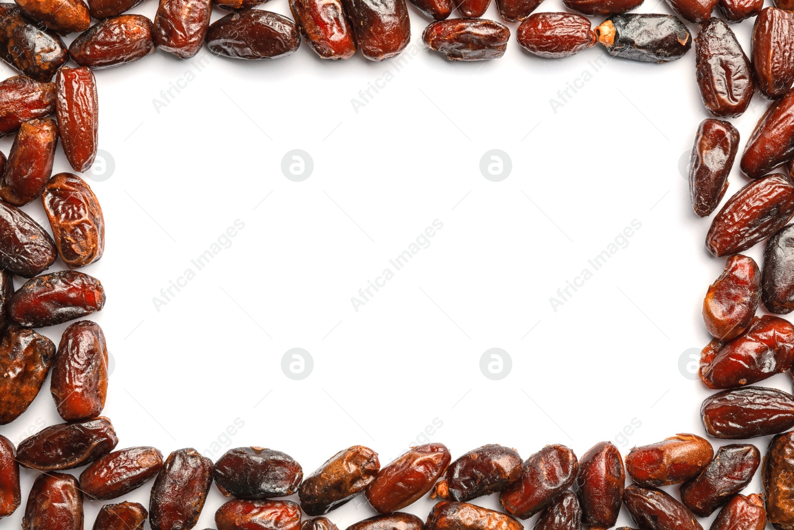 Photo of Frame made of sweet dried date fruits on white background, top view with space for text