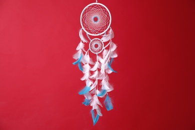 Beautiful dream catcher hanging on red background