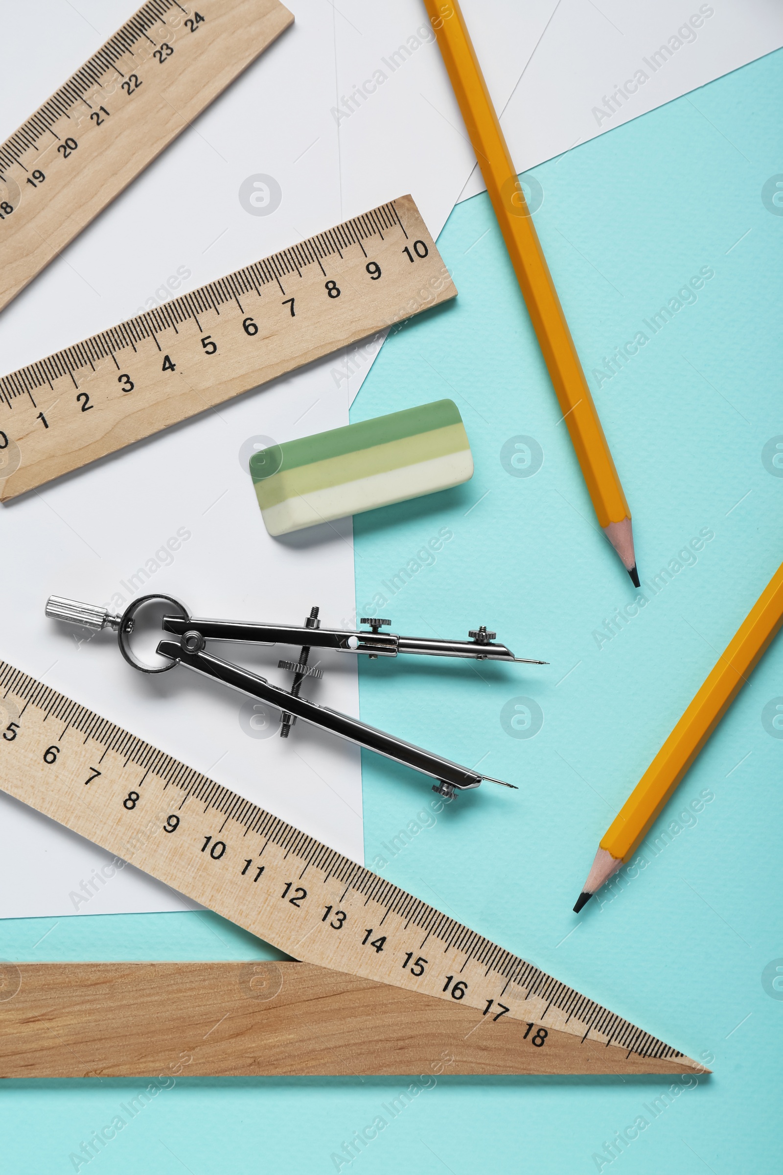 Photo of Different rulers, pencils and compass on turquoise background, flat lay