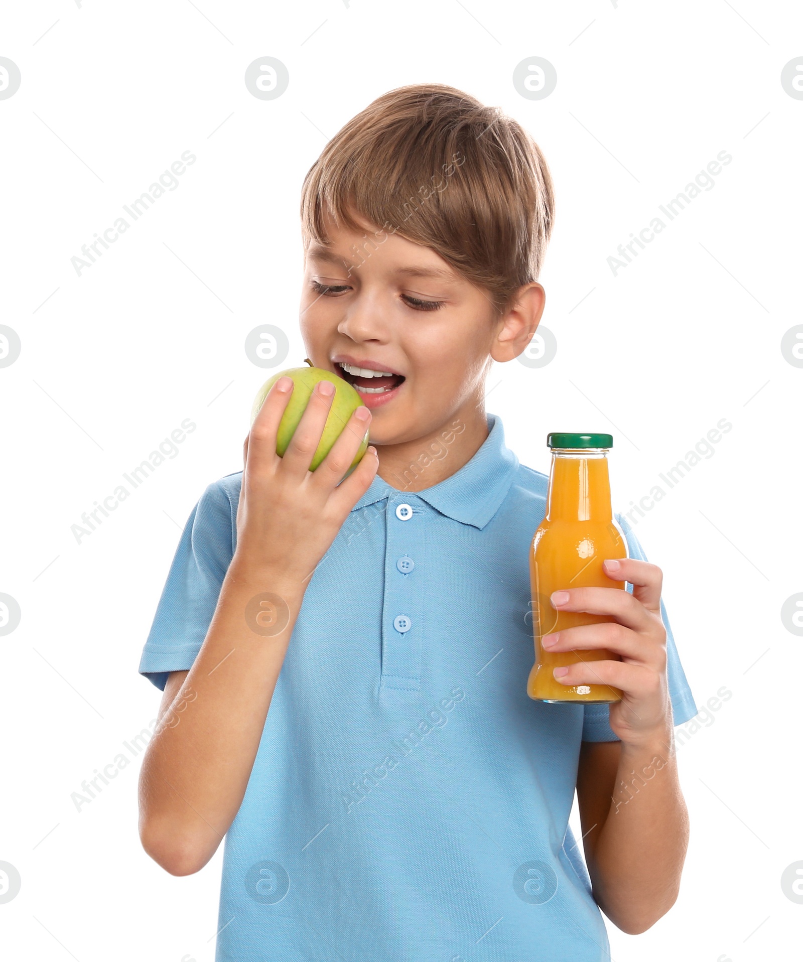 Photo of Little boy with bottle of juice and apple on white background. Healthy food for school lunch